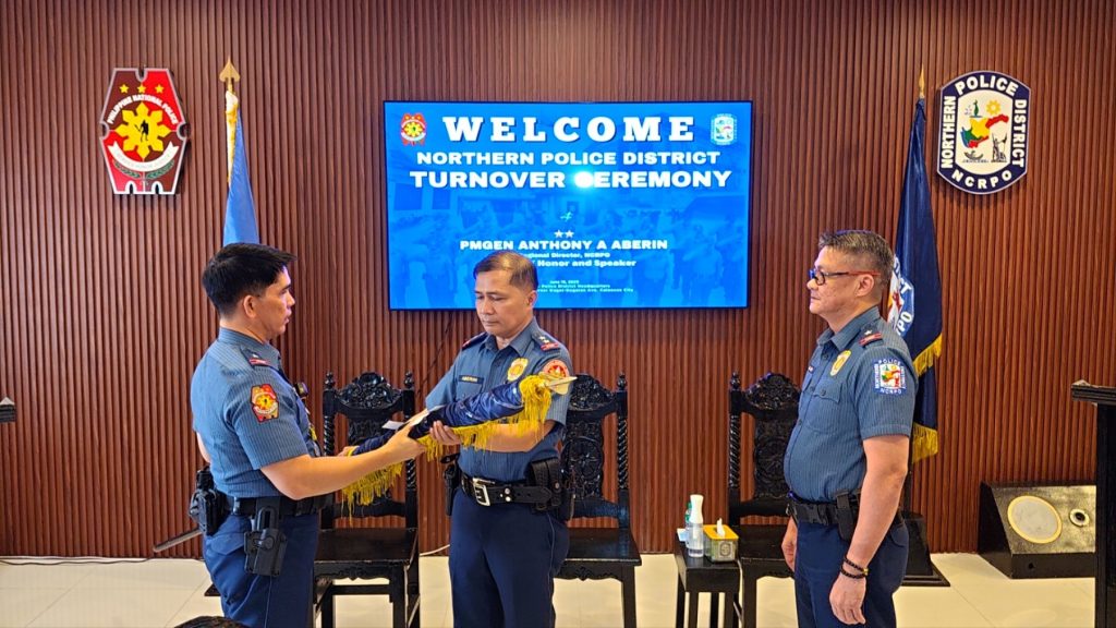 May be an image of 3 people and text that says '金 POLICE WELCOME NORTHERN POLICE DISTRICT TURNOVER EREMONY PMGEN PMGENANTHONYAABERIN ANTHONY ABERIN Honer and Speaker CRP'