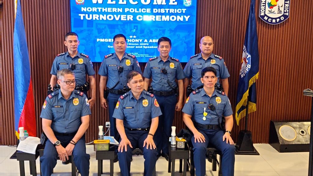 May be an image of 7 people and text that says 'NORTHERN POLICE DISTRICT TURNOVER COREMONY C PMGEI Guai NORTH M "HONYA ABF HONY HONYAABE Heo Direetor anor and Speaker ብር TRICT 0 製動た大時号 RPO AAEPИ'