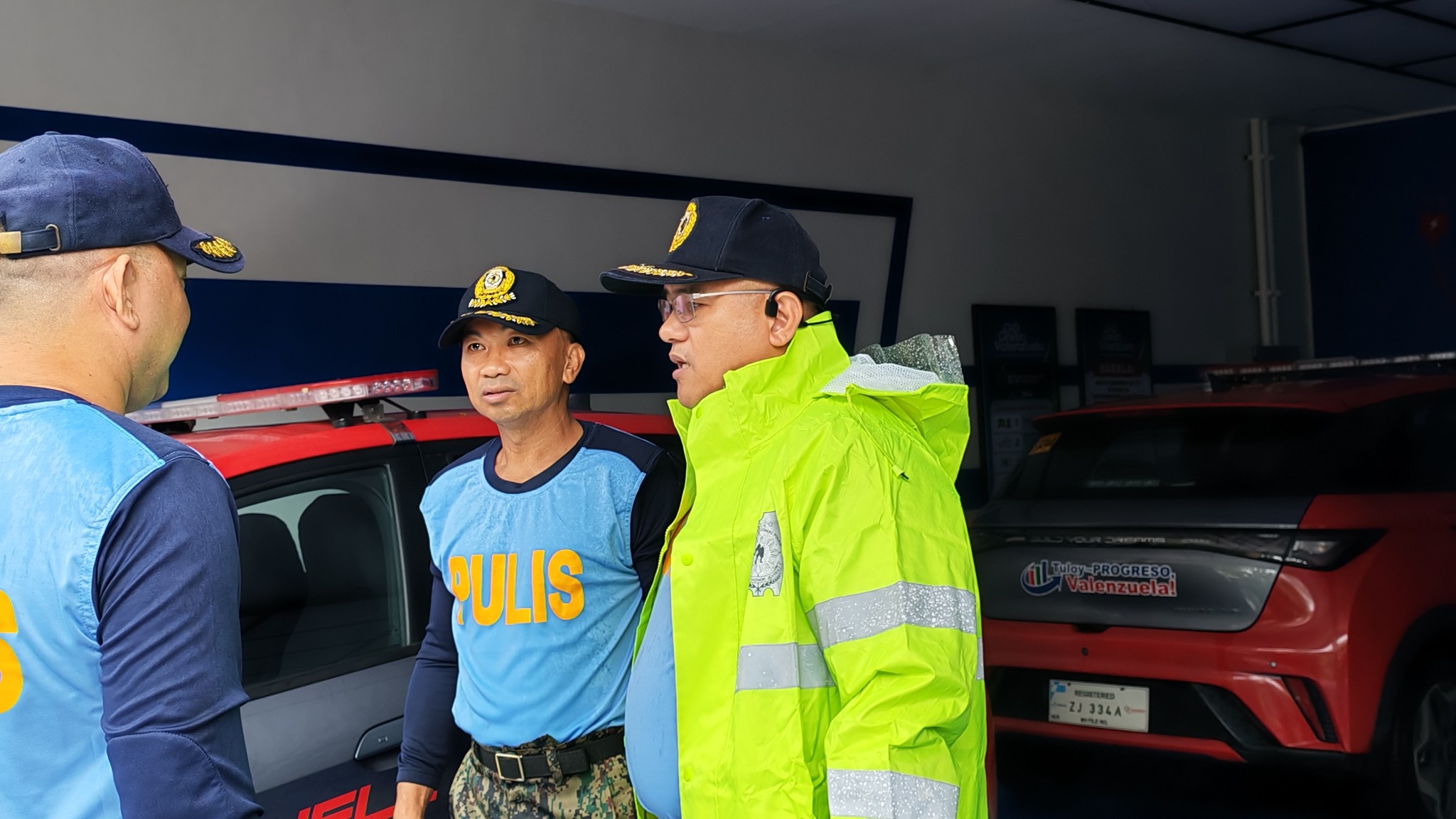May be an image of 2 people, car, ambulance and text